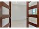Empty room with tiled floors visible through a set of modern doors at 4604 W Lowell Ave, Tampa, FL 33629
