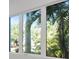 Scenic outdoor view framed by large windows, showcasing lush landscaping at 4604 W Lowell Ave, Tampa, FL 33629