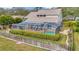 Aerial view of a screened-in pool and a large, well-maintained backyard with lush landscaping at 6208 Forrestal Dr, Tampa, FL 33625