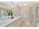 Elegant bathroom with double sinks, a luxurious vanity, and a glass-enclosed shower at 6208 Forrestal Dr, Tampa, FL 33625