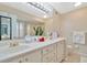 Spacious bathroom with double sinks, sleek vanity, and a large mirror illuminated by modern lighting at 6208 Forrestal Dr, Tampa, FL 33625