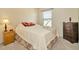 Comfortable bedroom with a queen bed, two side tables, and carpet flooring at 6208 Forrestal Dr, Tampa, FL 33625
