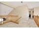 Upstairs hallway with neutral carpet and wood railing leads to bedrooms and other living spaces at 6208 Forrestal Dr, Tampa, FL 33625