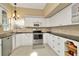 The renovated kitchen features white cabinets, granite countertops, and stainless steel appliances at 6208 Forrestal Dr, Tampa, FL 33625