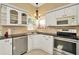 Kitchen featuring white cabinets, granite countertops, and stainless steel appliances, creating a modern and functional space at 6208 Forrestal Dr, Tampa, FL 33625