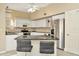 Bright kitchen featuring white cabinetry, granite countertops, stainless steel appliances and a breakfast bar at 6208 Forrestal Dr, Tampa, FL 33625