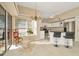 Bright kitchen with white cabinets, granite countertops, and stainless steel appliances adjacent to a dining area with ample natural light at 6208 Forrestal Dr, Tampa, FL 33625