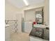 Functional laundry room with washer, dryer, storage cabinet, and a utility sink at 6208 Forrestal Dr, Tampa, FL 33625