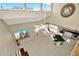 Open-concept living room with high ceilings, tile flooring, a ceiling fan, and a modern kitchen at 6208 Forrestal Dr, Tampa, FL 33625