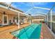 Beautiful in-ground swimming pool with a screened enclosure and brick patio for outdoor enjoyment at 6208 Forrestal Dr, Tampa, FL 33625