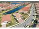 Aerial view of a home in a neighborhood with a lake, manicured lawns, and tree-lined streets at 624 Maraviya Blvd, Nokomis, FL 34275