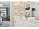 Bright bathroom with double vanity, a white countertop, stylish mirrors, and modern fixtures at 624 Maraviya Blvd, Nokomis, FL 34275