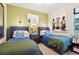 Cozy bedroom featuring twin beds, stylish decor, accent wall, and charming nautical-themed artwork for relaxing at 624 Maraviya Blvd, Nokomis, FL 34275