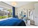 Bright bedroom features a large window, stylish mirror, luxury chandelier, and elegant decor for comfortable living at 624 Maraviya Blvd, Nokomis, FL 34275