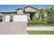 Charming home with a well-manicured lawn, a two-car garage, and a beautiful red brick driveway at 624 Maraviya Blvd, Nokomis, FL 34275