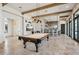 Spacious community game room with a pool table, bar area, and travertine tile flooring at 624 Maraviya Blvd, Nokomis, FL 34275