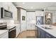 Well-designed kitchen with stainless steel appliances, white cabinetry, and a central island with barstool seating at 624 Maraviya Blvd, Nokomis, FL 34275