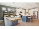 Spacious kitchen dining room features a large kitchen island, modern lighting, and stainless steel appliances at 624 Maraviya Blvd, Nokomis, FL 34275