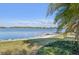 Scenic lake view with calm waters and waterfront residences, framed by lush landscaping at 624 Maraviya Blvd, Nokomis, FL 34275