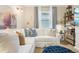 Inviting living room with a white couch, blue accents, and stylish decor creates a cozy and sophisticated space at 624 Maraviya Blvd, Nokomis, FL 34275