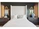 Comfortable main bedroom featuring a king-size bed, accent wall, and side tables at 624 Maraviya Blvd, Nokomis, FL 34275
