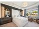 Luxurious main bedroom features a large window, accent wall, and stylish décor at 624 Maraviya Blvd, Nokomis, FL 34275