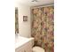 Cozy bathroom with patterned shower curtain, white vanity, and matching toilet at 6287 Bahia Del Mar Cir # 101, St Petersburg, FL 33715