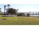 Scenic waterfront community grounds with lush green lawns, palm trees, and a pergola overlooking the ocean at 6287 Bahia Del Mar Cir # 101, St Petersburg, FL 33715