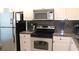 Modern kitchen with stainless steel appliances and granite countertops at 6287 Bahia Del Mar Cir # 101, St Petersburg, FL 33715