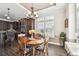 Sunlit dining area featuring a classic chandelier, wood table, and a view to the kitchen at 6580 Seminole Blvd # 417, Seminole, FL 33772