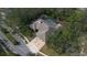 Aerial view of a large home with a screened pool area, lush trees, and a well manicured lawn at 70 Deerpath Dr, Oldsmar, FL 34677