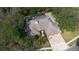 Stunning aerial view of home featuring a screened pool and lush landscaping at 70 Deerpath Dr, Oldsmar, FL 34677