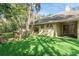 Spacious backyard with lush green lawn and mature trees at 70 Deerpath Dr, Oldsmar, FL 34677