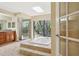 Bathroom featuring a jacuzzi tub, glass shower and wood cabinetry at 70 Deerpath Dr, Oldsmar, FL 34677