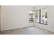 An empty room with neutral walls, carpet floors, and a corner window at 70 Deerpath Dr, Oldsmar, FL 34677