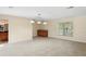 Open dining area with a wet bar and view to a bathroom, ready for entertaining and relaxation at 70 Deerpath Dr, Oldsmar, FL 34677