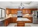 Gourmet kitchen with custom wood cabinetry, granite countertops, modern stainless steel appliances, and a center island at 70 Deerpath Dr, Oldsmar, FL 34677
