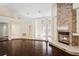 Bright living room featuring wood floors, stone fireplace, and an open floor plan with decorative columns at 70 Deerpath Dr, Oldsmar, FL 34677