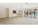 Spacious living room with tile floors, neutral walls, and a view to the pool at 70 Deerpath Dr, Oldsmar, FL 34677