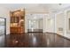 Living room with wood floors, a wet bar, and a view through the house at 70 Deerpath Dr, Oldsmar, FL 34677