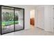 Living room featuring sliding doors to the backyard and neutral tile floors at 70 Deerpath Dr, Oldsmar, FL 34677