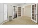 Bright living room with a tile floor, sliding doors to the patio, and multiple entryways at 70 Deerpath Dr, Oldsmar, FL 34677