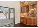 Wet bar with stone accents and pool view at 70 Deerpath Dr, Oldsmar, FL 34677