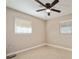 Bedroom with tiled floor, ceiling fan, and two windows offering natural light at 7000 52Nd N Ln, Pinellas Park, FL 33781