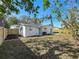 Backyard featuring a fence, an AC unit, a sliding door, and landscaping at 9095 52Nd N St, Pinellas Park, FL 33782