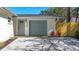 Attached garage and concrete driveway with new landscaping and an adjacent wooden fence at 9095 52Nd N St, Pinellas Park, FL 33782