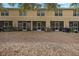 A carpet of leaves covers this backyard in a condominium neighborhood with multiple screened in patios at 10944 Keys Gate Dr, Riverview, FL 33579