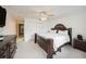 Spacious bedroom with a decorative dark wood bed frame, ceiling fan, and closet at 10944 Keys Gate Dr, Riverview, FL 33579