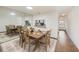 Elegant dining room with a large mirror, wood-look floors, and a dining table set for a meal at 10944 Keys Gate Dr, Riverview, FL 33579