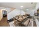 Bright dining area with an expansive mirror, wood-look floors, and a cozy dining set for Gathering meals at 10944 Keys Gate Dr, Riverview, FL 33579